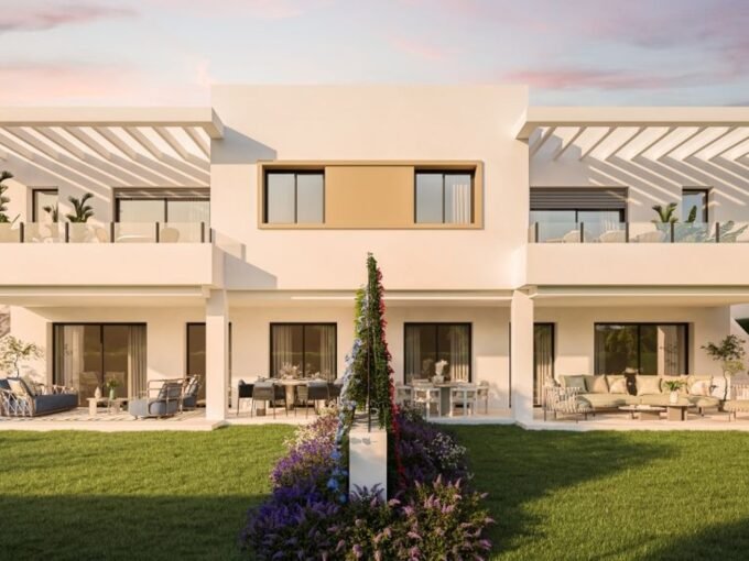 Facades and private gardens at dusk at Apron Estepona, Estepona Golf