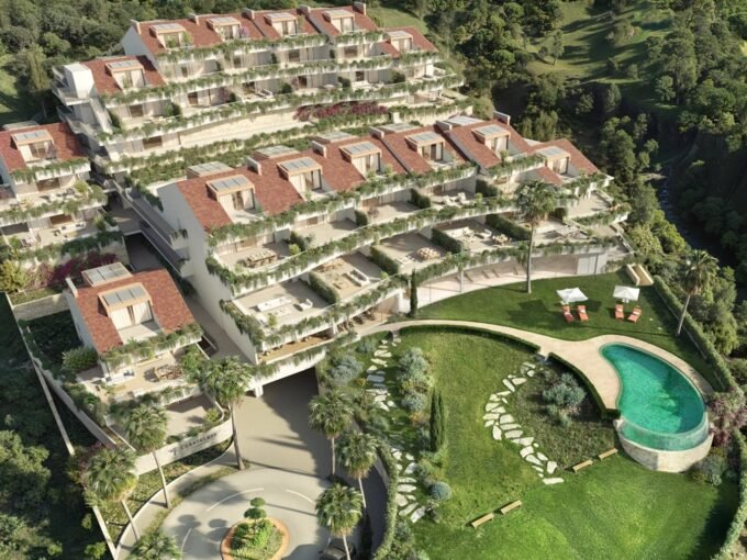 Aerial view of the terraced blocks and curved pool at Casatalaya Residences, Torremuelle, Benalmadena