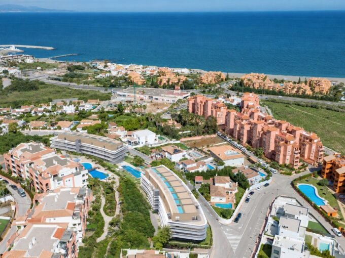Aerial view of the two crescent blocks and the Manilva coastline at Moon 64, Manilva