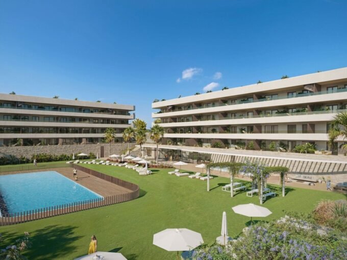 Daytime view of the residential blocks over the communal pool and lawned gardens at Ocean Garden, Fuengirola