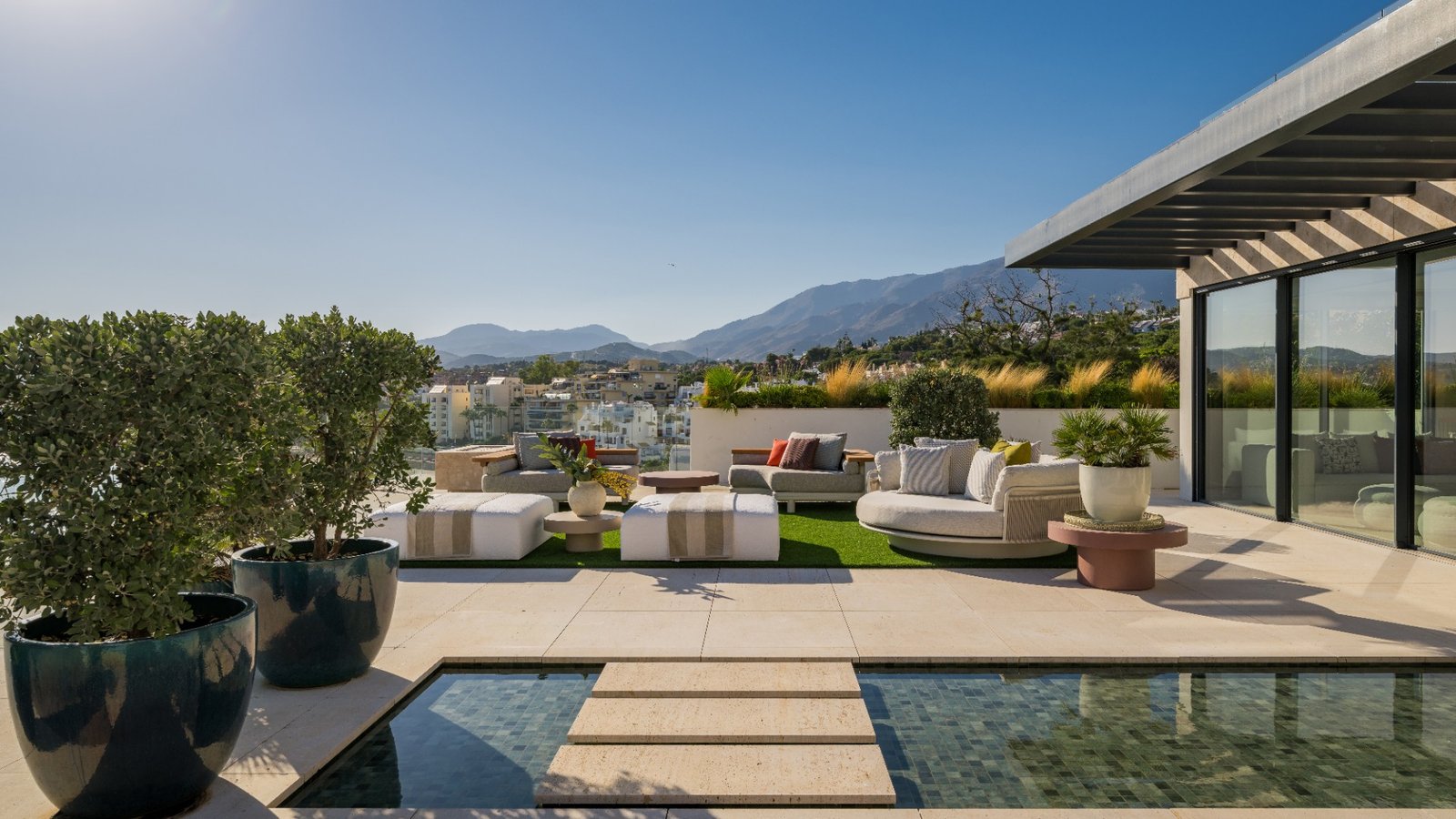Private terrace with water feature, planting and mountain views at Atelier 4 Ikkil Bay, Estepona
