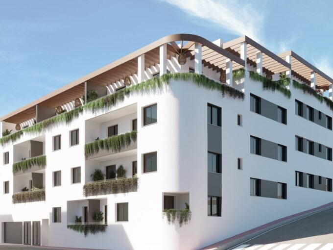 Exterior view of the white four-storey building with planted terraces at Laguna Nova, Las Lagunas de Mijas